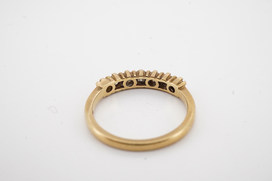 A modern 18ct gold and seven stone diamond set half hoop ring size O, gross weight 3.2 grams.